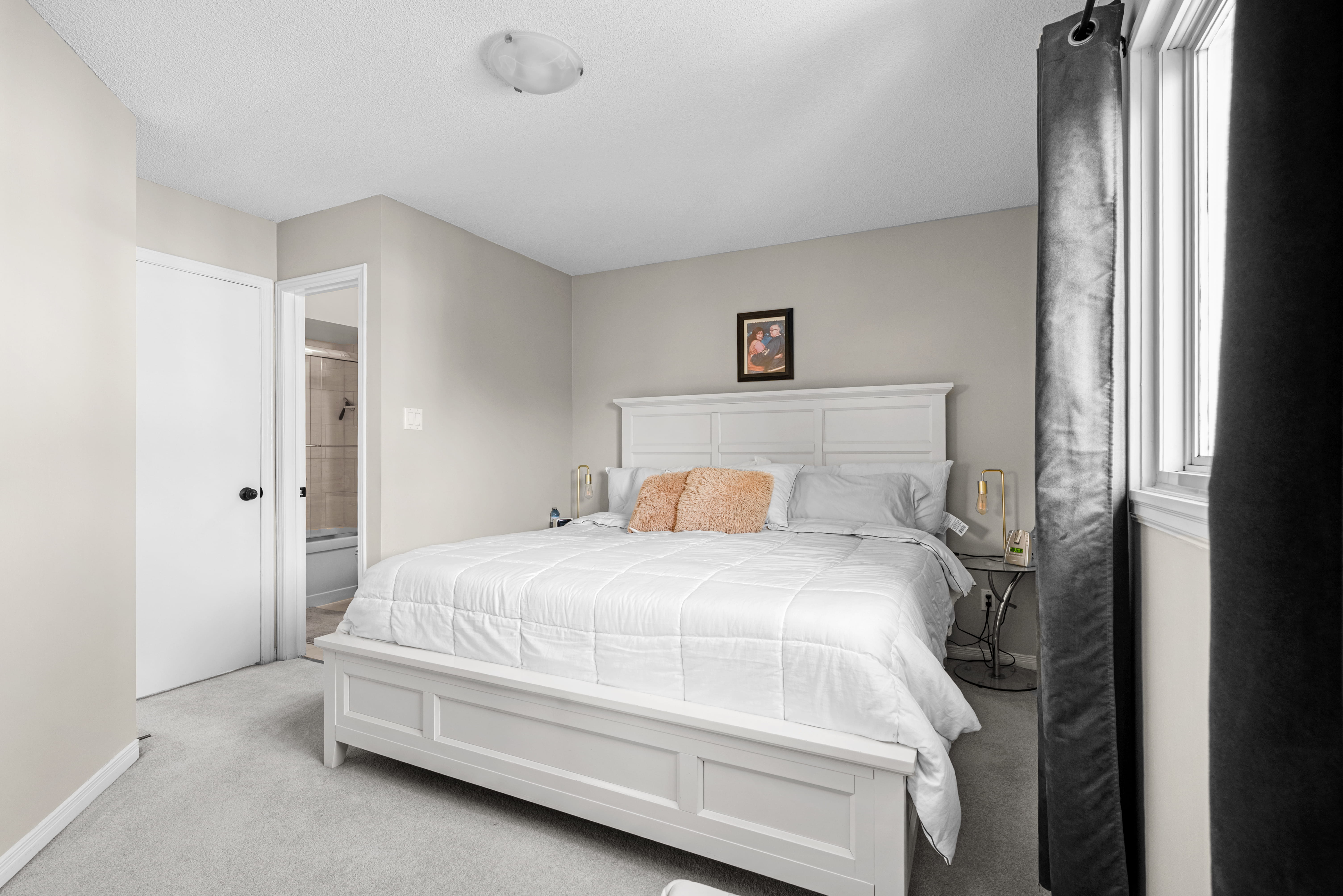 Primary bedroom with clean styling and natural light